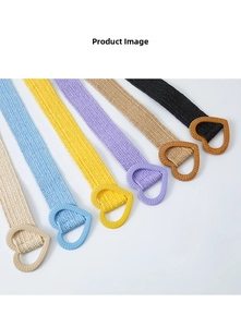 Detail showing various colors of woven belts with heart-shaped buckles and straw texture