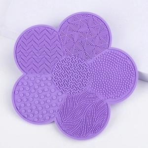 Detailed view of the lavender floral silicone makeup brush cleaning mat with varied textures