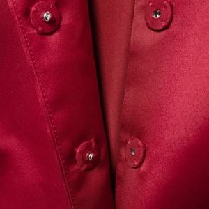 Elegant red satin Christmas set featuring a detailed snap button closure on smooth fabric