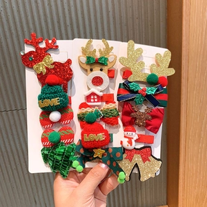 Close-up of festive Christmas hair clips featuring reindeer, snowmen and glitter trees
