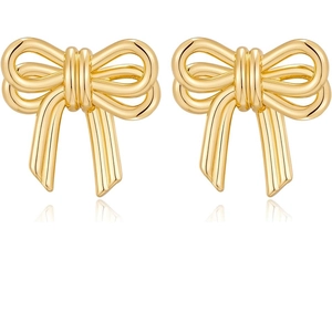 Close-up of polished golden bow stud earrings with a glossy metallic mirror finish