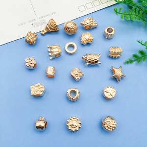 Vintage KC gold crown and animal alloy beads set for DIY jewelry making on blue background