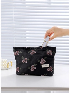 Floral embroidered black jacquard makeup bag with satin finish and zipper closure