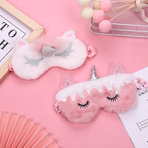 Cute unicorn plush sleep mask in pink and white with rainbow gradient details