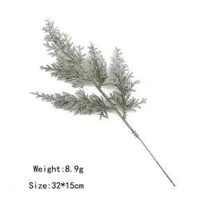 Detail showing artificial frosted pine branch with dimensions 32x15cm and 8.9g weight
