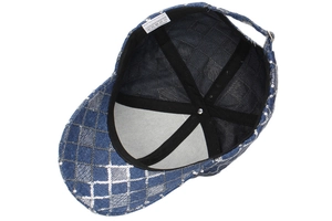 Detail of blue denim style baseball cap with interior polyester lining and silver sequins