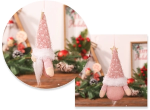 Macro detail of pink knitted Christmas gnome hanging ornament with star and faux beard