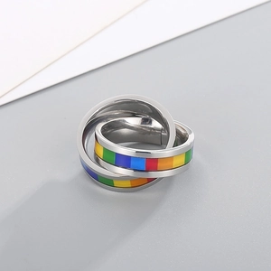 Macro shot of interlocking rainbow rings made of stainless steel with colorful stripes