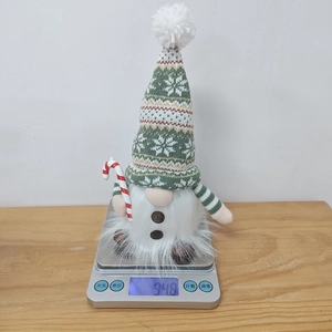 Weight measurement of knit Christmas gnome with candy cane and festive LED lights