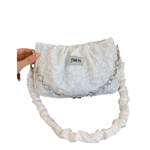 White textured ruched underarm bag with flower metal chain and soft fabric strap