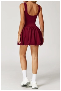 Detail of burgundy tennis dress with backless U-neck and bubble skirt for sports