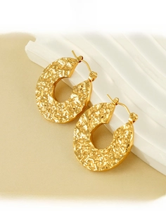 Detailed view of hammered 18K gold plated titanium steel hoop earrings with texture
