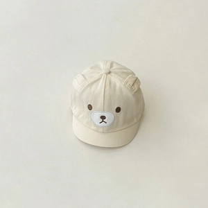 Detailed close-up of cream cotton baby baseball cap with 3D bear ears and embroidery