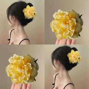 Detailed views of yellow flower hair clip showing 3D petals and side-wear styling on model