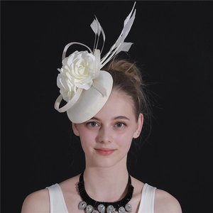Elegant white mesh fascinator hat featuring fabric flowers and delicate feathers on model