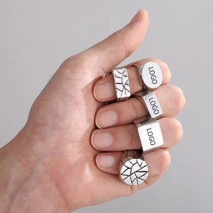 Detail showing customizable signet rings with laser logo placement on silver band