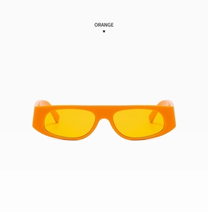 Macro shot of stylish orange rectangular narrow frame sunglasses with flat top design