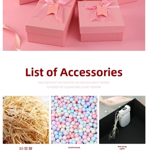 Pink gift box set with satin ribbon, shredded paper filler and LED string lights detail