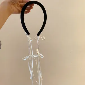 Elegant fabric headband with white satin bows and beaded tassels in black and white