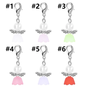 Detailed close-up of six colorful angel charms with wings and lobster clasps for gifts