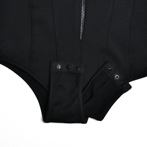 Detail shot of the adjustable snap crotch closure on a black long sleeve bodysuit