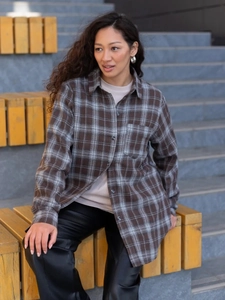 Detail of vintage oversized plaid shirt with chest pocket and premium button texture