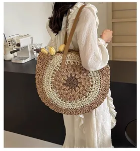 Detail of hand-woven paper rope beach bag with colored circular pattern and leather strap