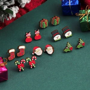 Detailed view of festive Christmas wooden stud earrings set with Santa and snowman designs