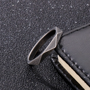 Minimalist geometric cut ring in vintage silver finish on black leather surface