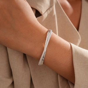 Detail of 18k gold plated silver bangle with pave cubic zirconia on female wrist