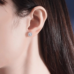 Close-up of elegant cushion cut moissanite halo stud earrings in 925 sterling silver