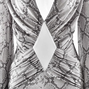 Detail of snakeskin print maxi dress featuring deep V-neck and waist cutout detail