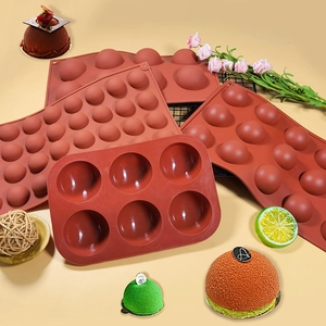 Multiple sizes of brick red semi-sphere silicone baking molds for cakes and chocolates