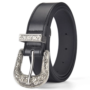 Detail of black leather belt with engraved silver buckle and retro western stitching