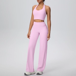 Detail of light pink halter yoga set featuring sports top and high waist wide leg pants