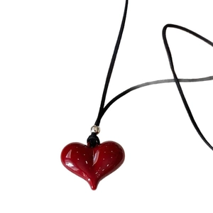 Elegant long necklace featuring a glossy red heart pendant with a slim black cord