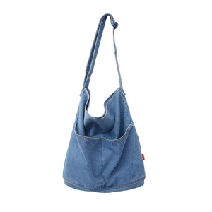 Classic blue denim crossbody bag with large front pockets and adjustable shoulder strap