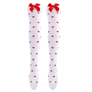 Detail of white over-the-knee socks with red heart patterns and knitted red bows