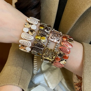 Close-up of vintage enamel heart stretch bracelets with hollow square patterns and rhinestones