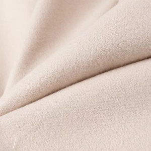 Short double-breasted woolen jacket in soft beige oatmeal fabric texture view