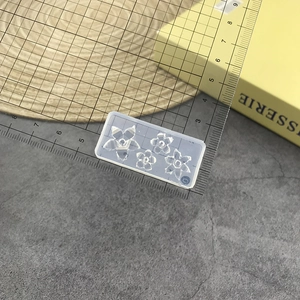Detail of transparent silicone nail art mold featuring four sizes of rose flower shapes