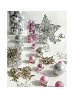 Detail of silver hollow star tree topper and pink Christmas balls on white background