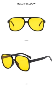 Detail of pilot sunglasses featuring double bridge black frames and vivid yellow lenses
