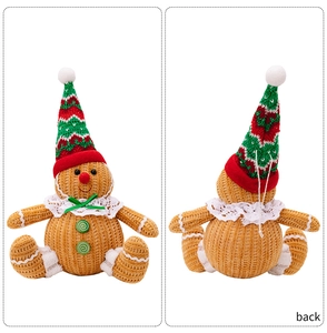 Front and back detail of knitted gingerbread man plush doll with festive Christmas hat