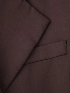 Detail shot of twill texture and pocket flap on dark brown blazer for women