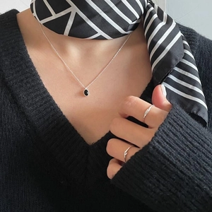 Elegant 925 sterling silver oval necklace and minimalist ring set on casual outfit