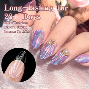 Macro detail of long almond press-on nails with 3D diamond texture and pearl accents
