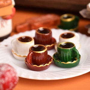 Macro shot of miniature coffee cups and saucers with gold rims for dollhouse decor
