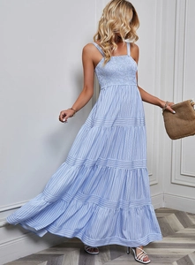 Detailed shot of the blue and white striped summer dress with smocked bodice and tiered hem