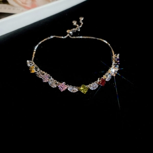 Macro detail of multi-colored zircon stones and adjustable sliding clasp on silver bracelet